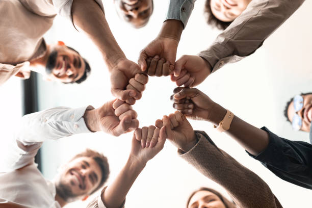 Convivity team members joining fists together